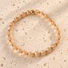 Armband facet champagne op lichte natuurstenen plaat